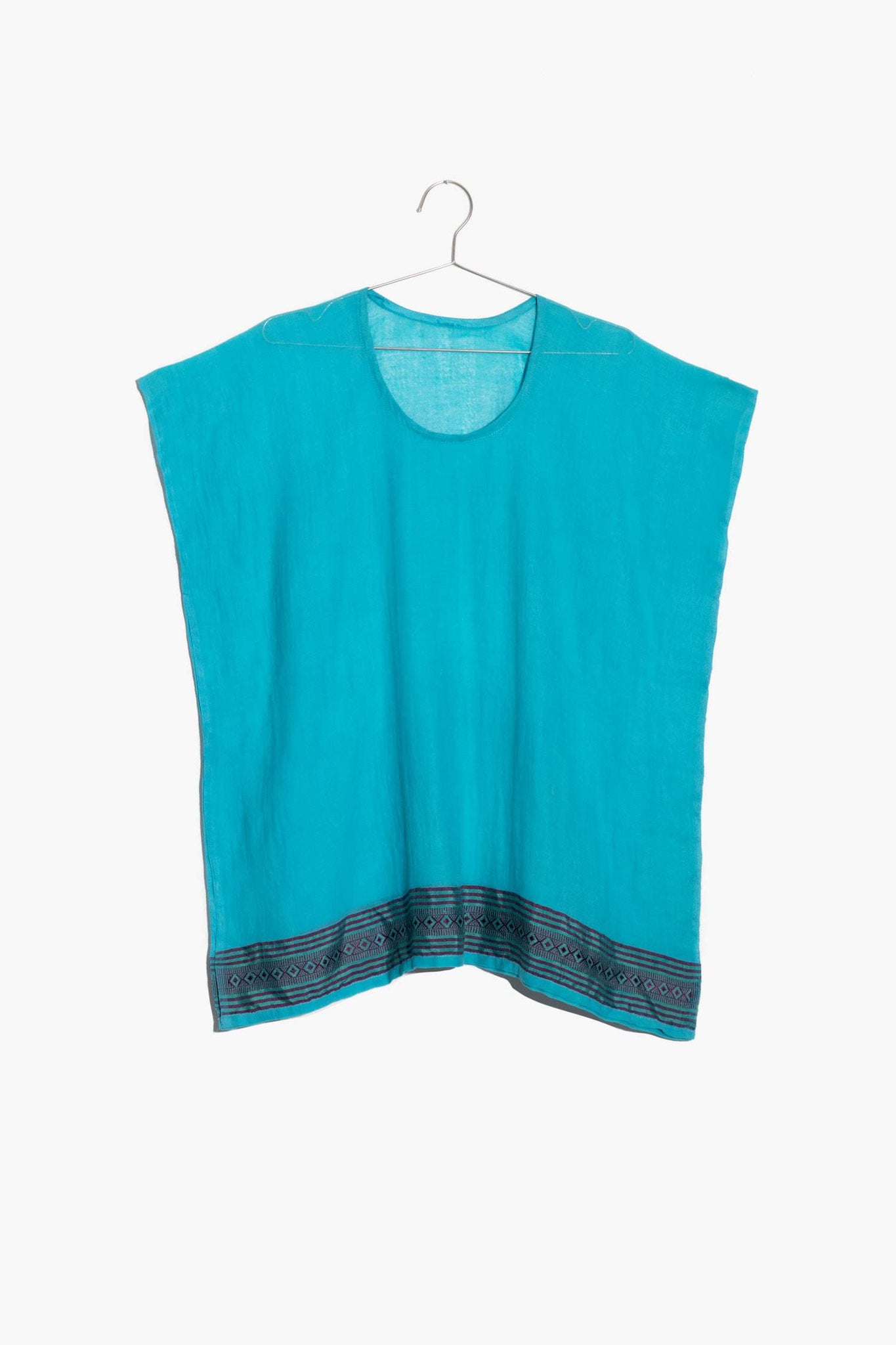 The Mimi Top is like your oversized tee but better. This semi-sheer cotton top is comfy without sacrificing style. It features a rich pattern along the bottom hem, inspired by Ethiopian textile design.