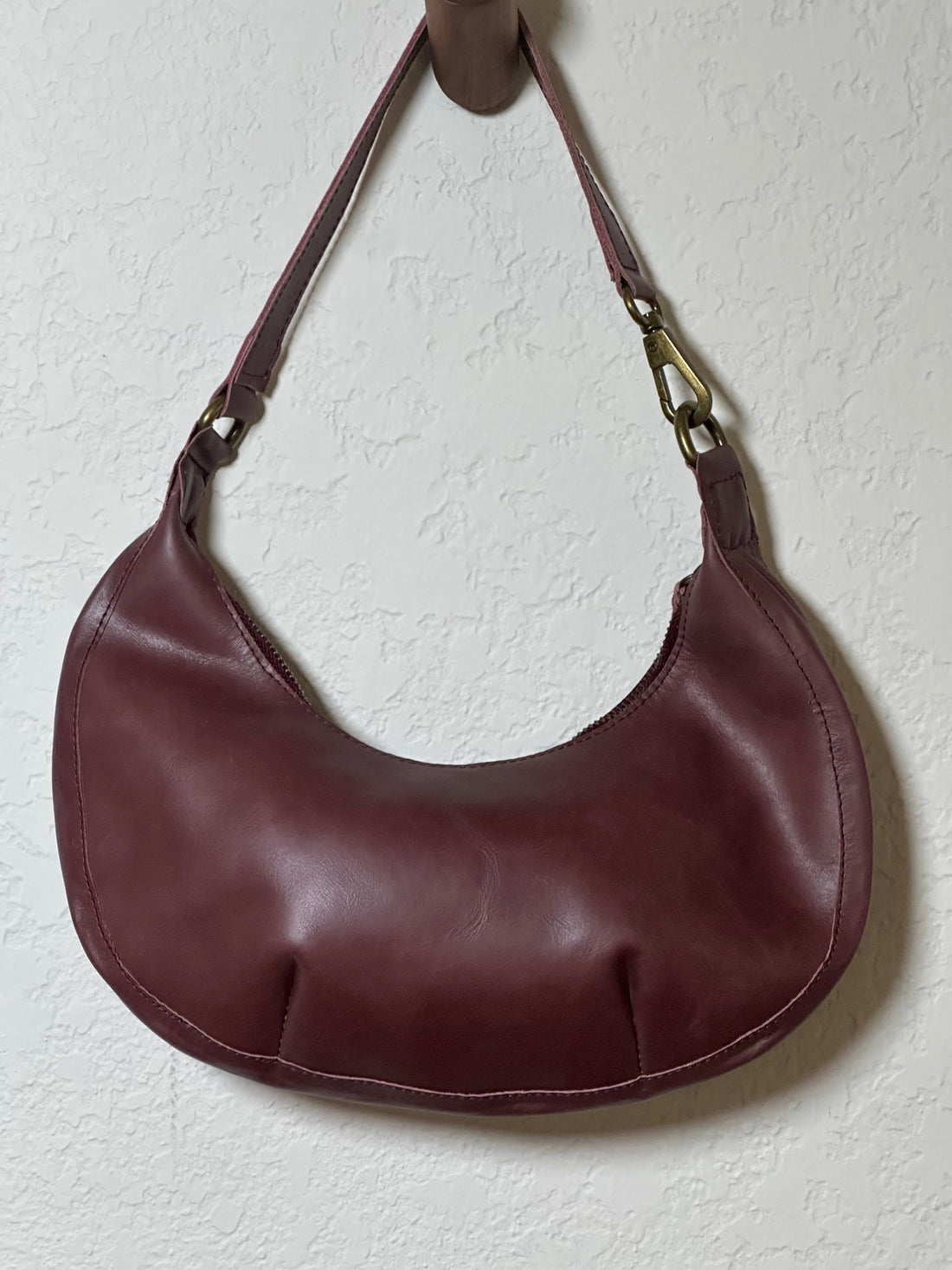 Bella Crescent Shoulder Bag in Garnet Desert Rose — artisan-made shoulder bag in plum purple upcycled leather with a smooth back panel, sculptural crescent silhouette, and secure zip closure.