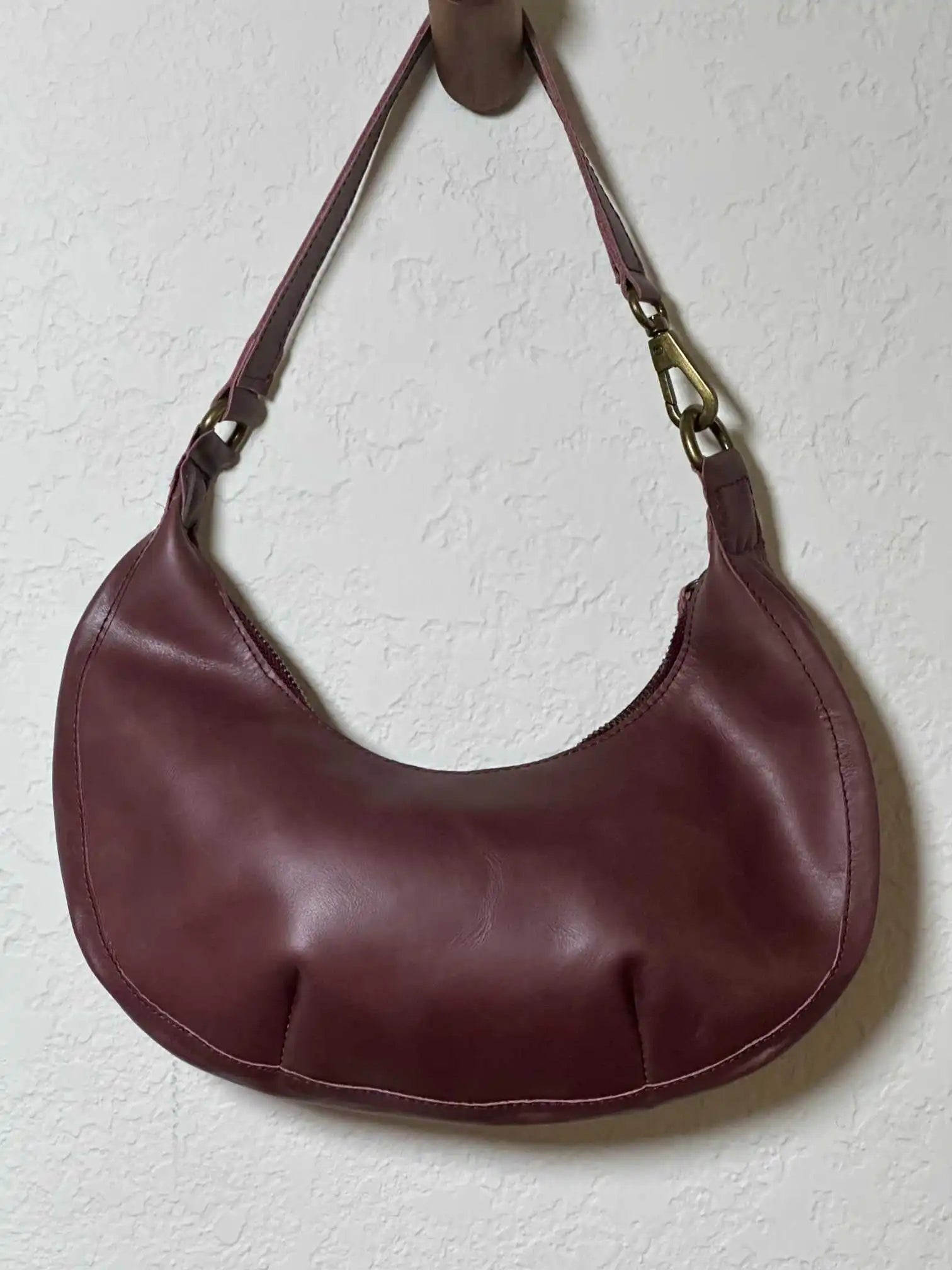 Bella Crescent Shoulder Bag in Garnet Desert Rose — artisan-made shoulder bag in plum purple upcycled leather with a smooth back panel, sculptural crescent silhouette, and secure zip closure.