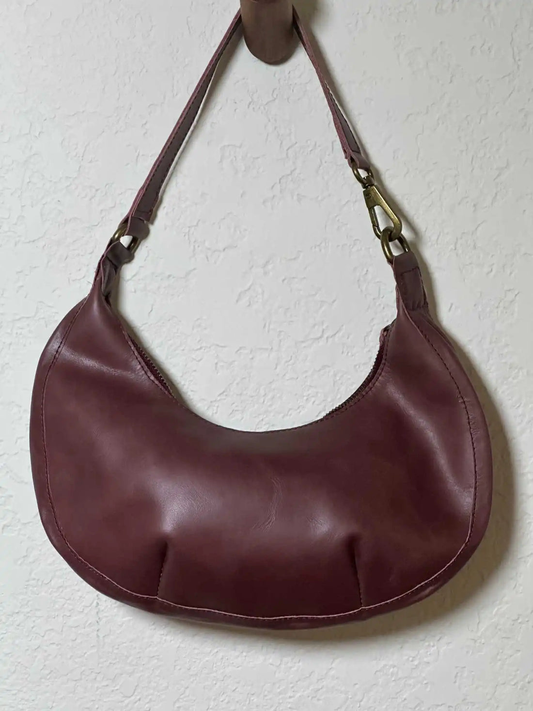 Bella Crescent Shoulder Bag in Garnet Desert Rose — artisan-made shoulder bag in plum purple upcycled leather with a smooth back panel, sculptural crescent silhouette, and secure zip closure.
