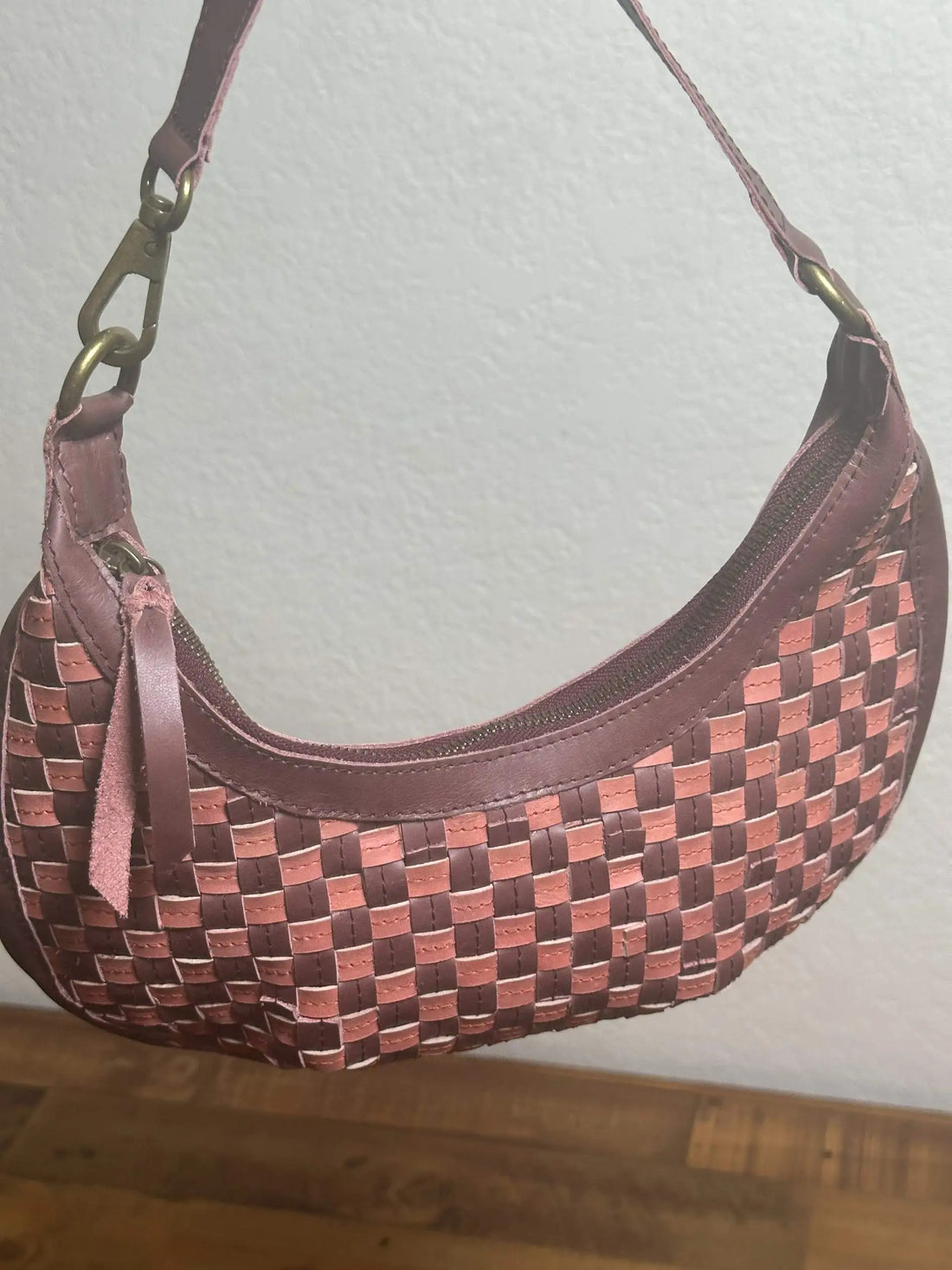 Bella Crescent Shoulder Bag in Garnet Desert Rose — handcrafted in Ethiopia with a handwoven checkered weave in plum purple, dusty rose pink, and deep burgundy upcycled leather.