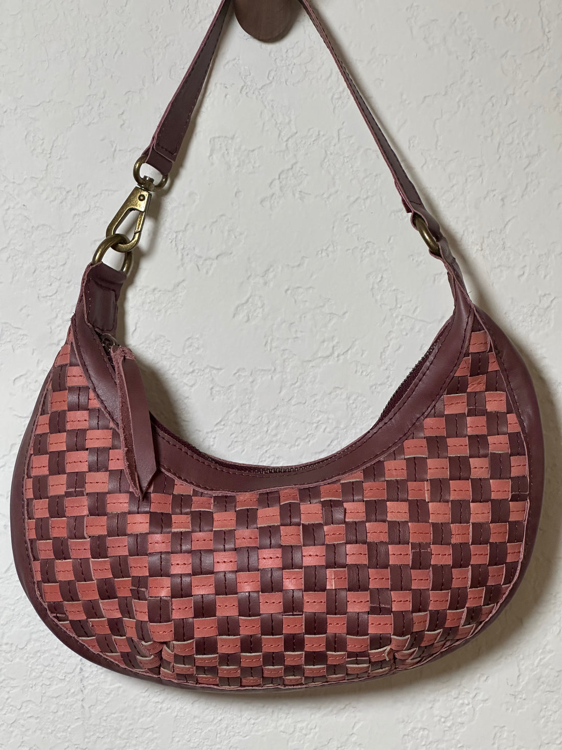 Bella Crescent Shoulder Bag in Garnet Desert Rose — handcrafted in Ethiopia with a handwoven checkered weave in plum purple, dusty rose pink, and deep burgundy upcycled leather. — handcrafted in Ethiopia with a handwoven checkered weave in plum purple, dusty rose pink, and deep burgundy upcycled leather.