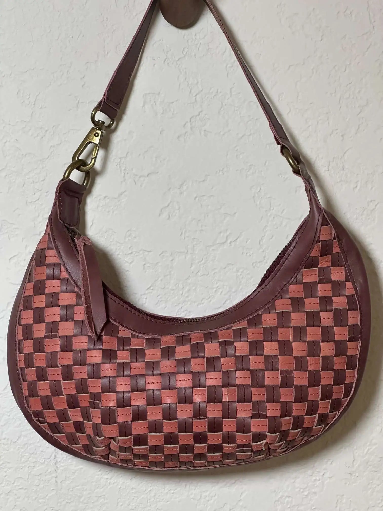 Bella Crescent Shoulder Bag in Garnet Desert Rose — handcrafted in Ethiopia with a handwoven checkered weave in plum purple, dusty rose pink, and deep burgundy upcycled leather. — handcrafted in Ethiopia with a handwoven checkered weave in plum purple, dusty rose pink, and deep burgundy upcycled leather.a