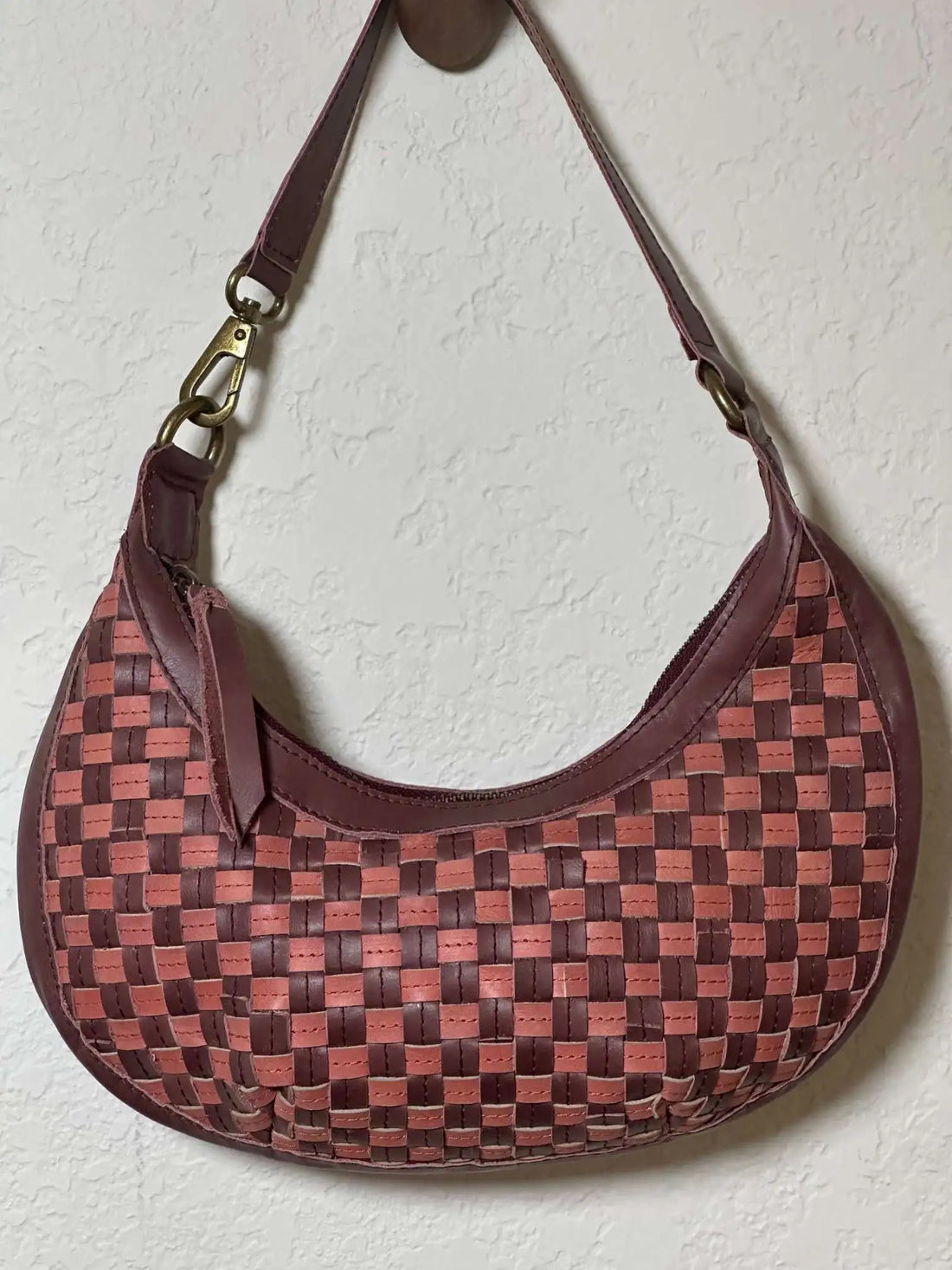 Bella Crescent Shoulder Bag in Garnet Desert Rose — handcrafted in Ethiopia with a handwoven checkered weave in plum purple, dusty rose pink, and deep burgundy upcycled leather. — handcrafted in Ethiopia with a handwoven checkered weave in plum purple, dusty rose pink, and deep burgundy upcycled leather.a