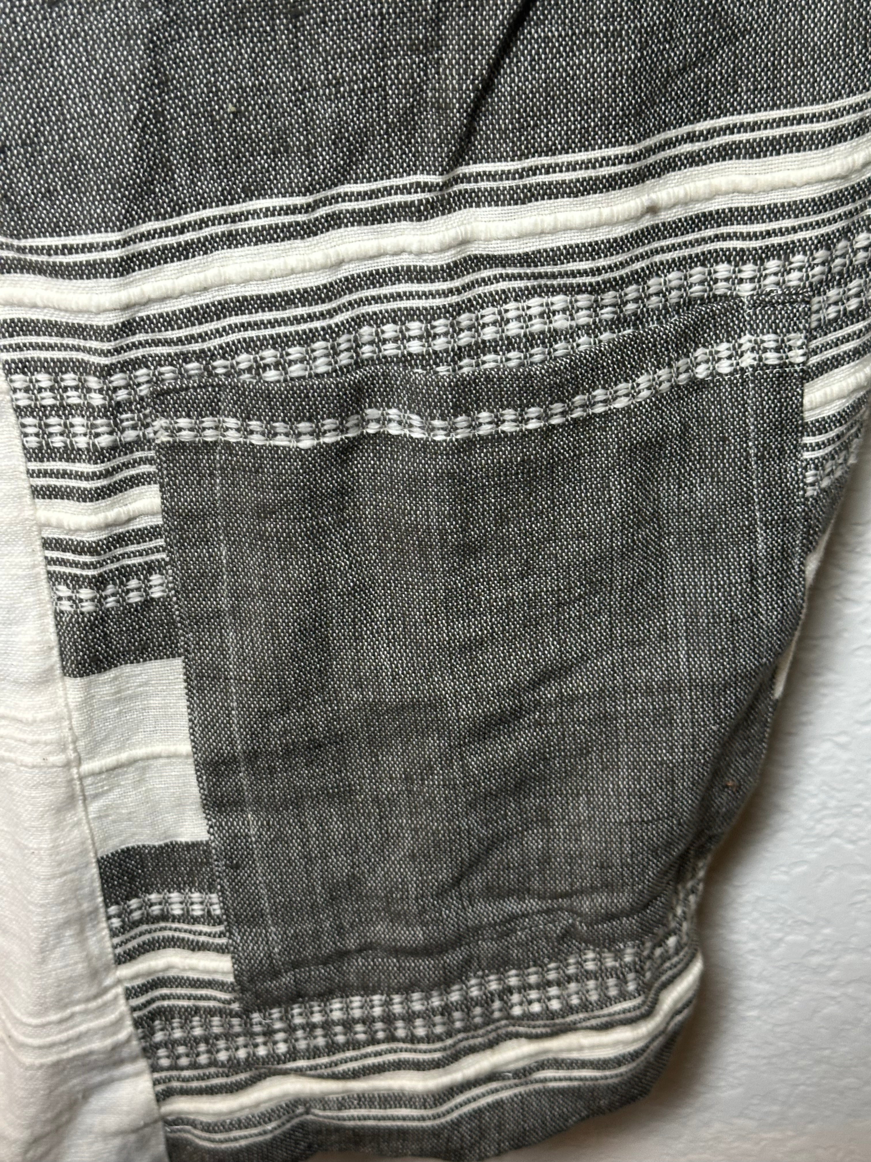 Close-up of a black and white striped fabric with intricate patterns.