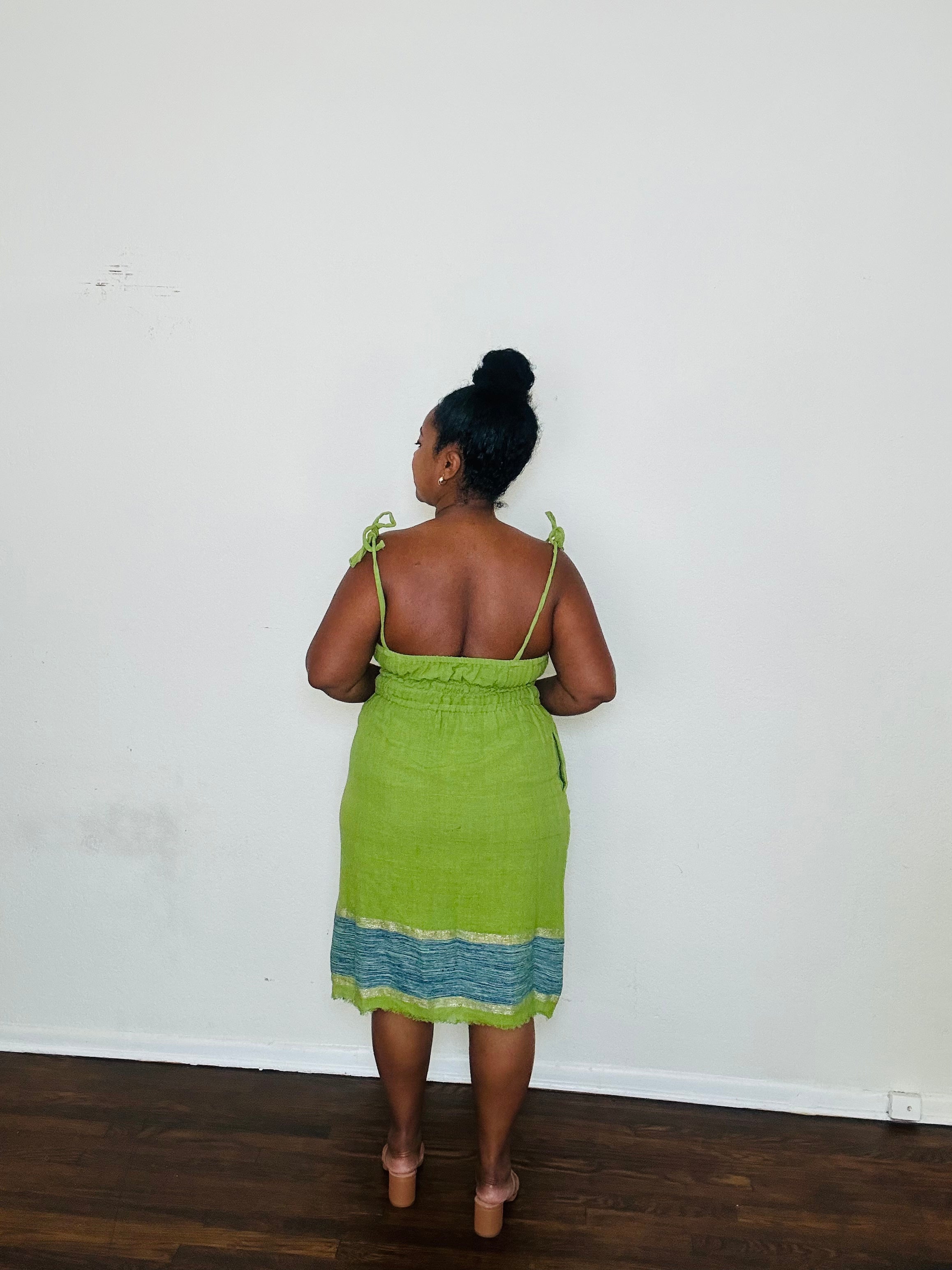 Enani Dress Lime Aura — handmade 100% cotton short dress in lime green with contrasting blue hem, straight neckline, adjustable straps, cinched waist, and hidden pockets.