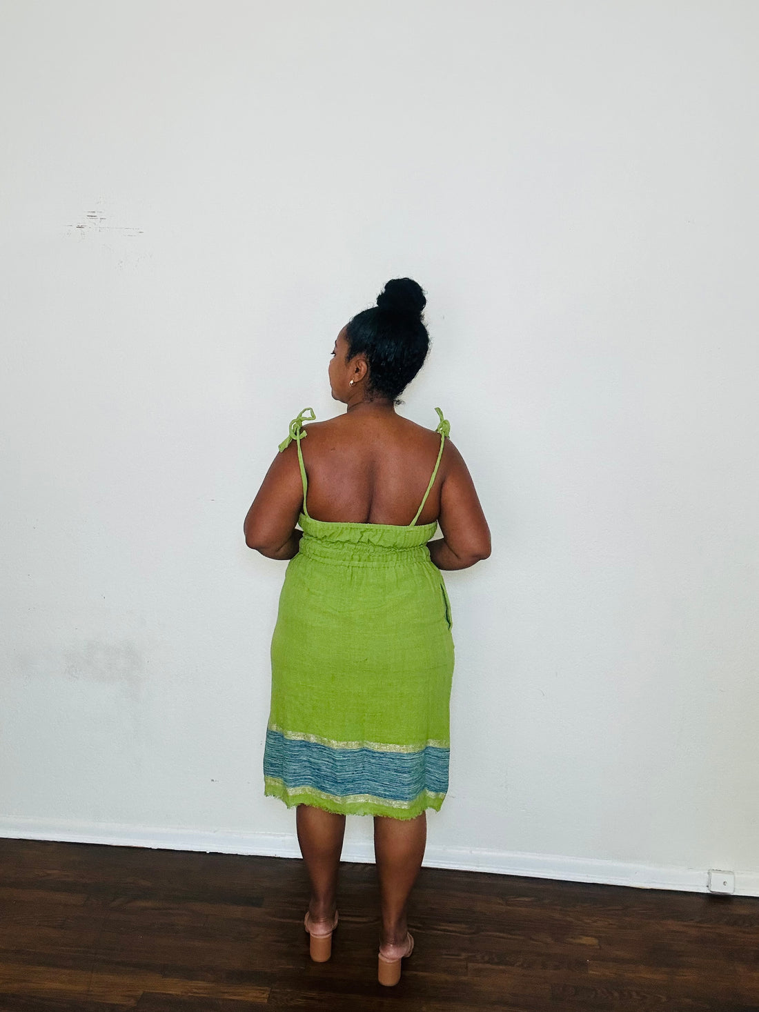 Enani Dress Lime Aura — handmade 100% cotton short dress in lime green with contrasting blue hem, straight neckline, adjustable straps, cinched waist, and hidden pockets.