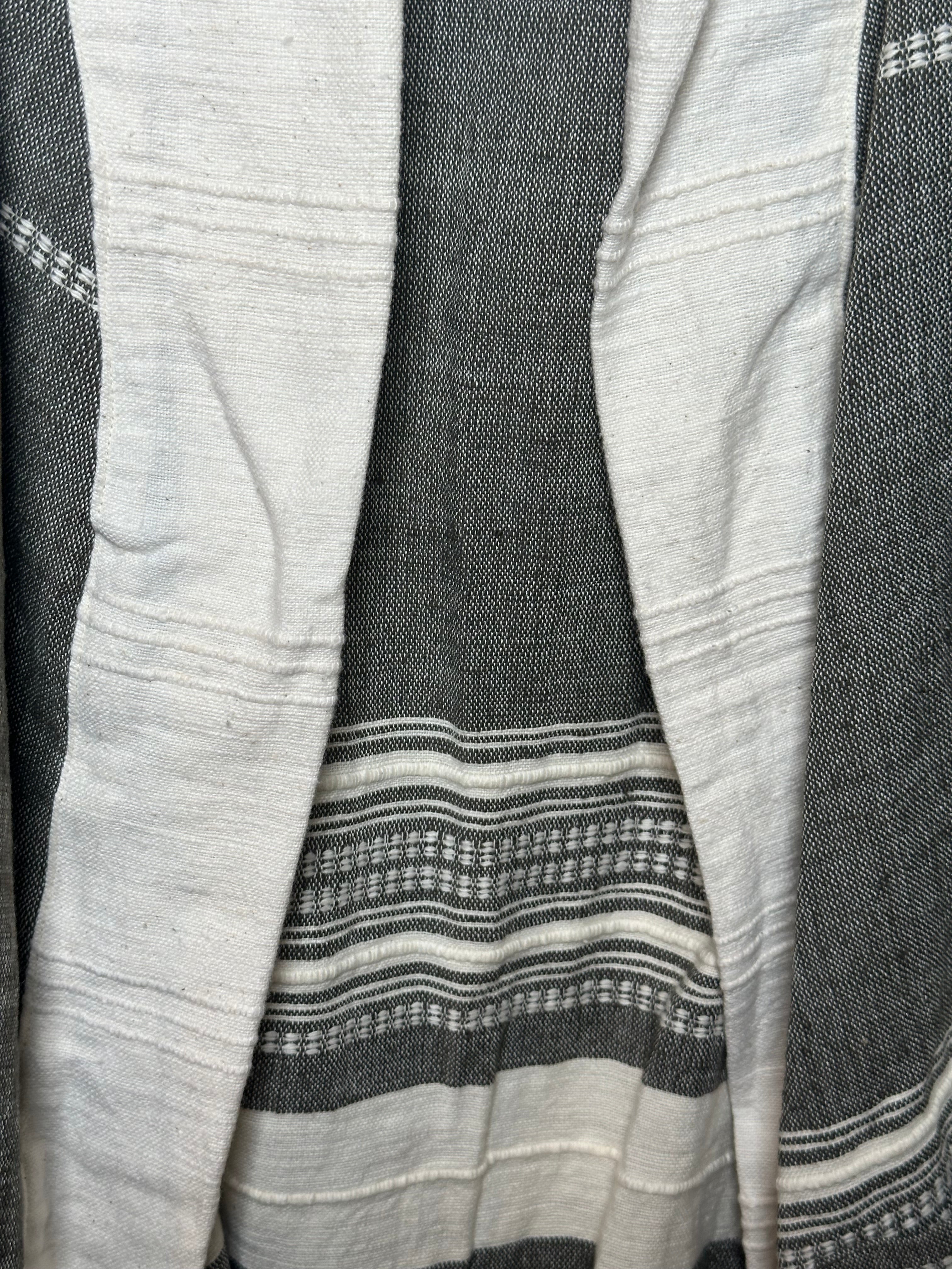 Stack of folded fabric with gray and white stripes