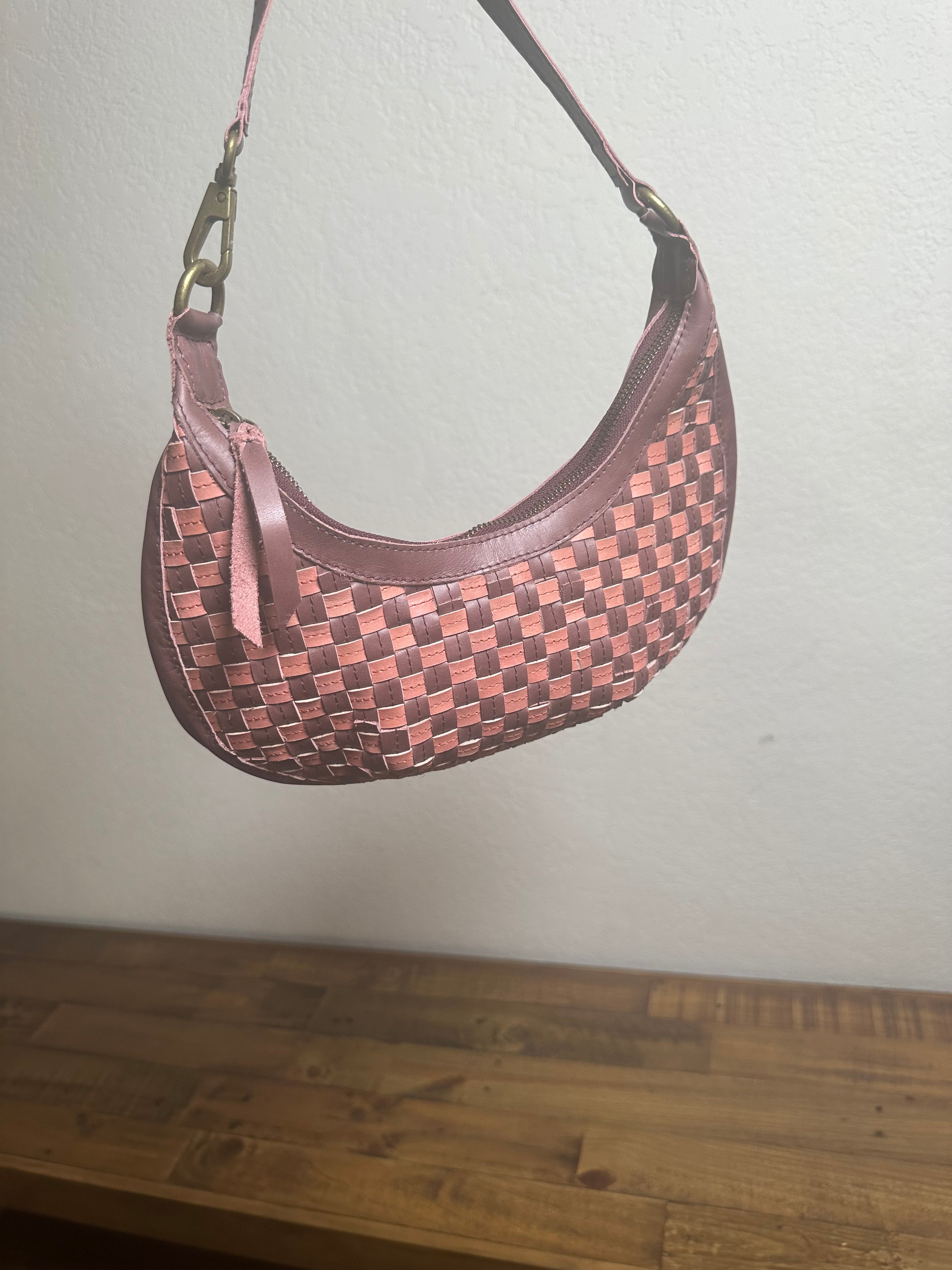 Limited-edition Bella Crescent Shoulder Bag in Garnet Desert Rose — artisan-crafted upcycled leather bag with checkered weave in plum, dusty rose, and burgundy, designed as a sculptural crescent silhouette.