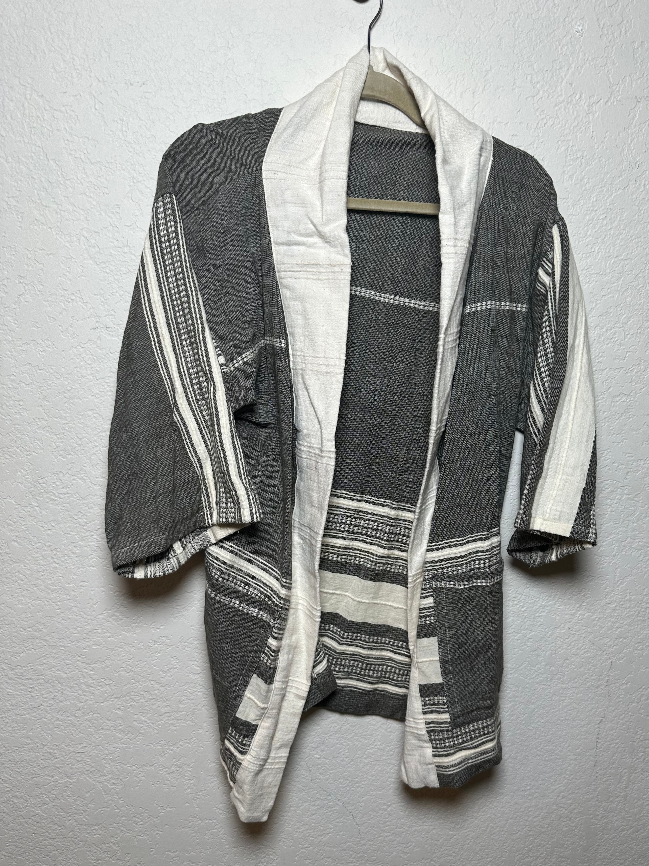 Folded fabric with gray and white stripes on a gray surface