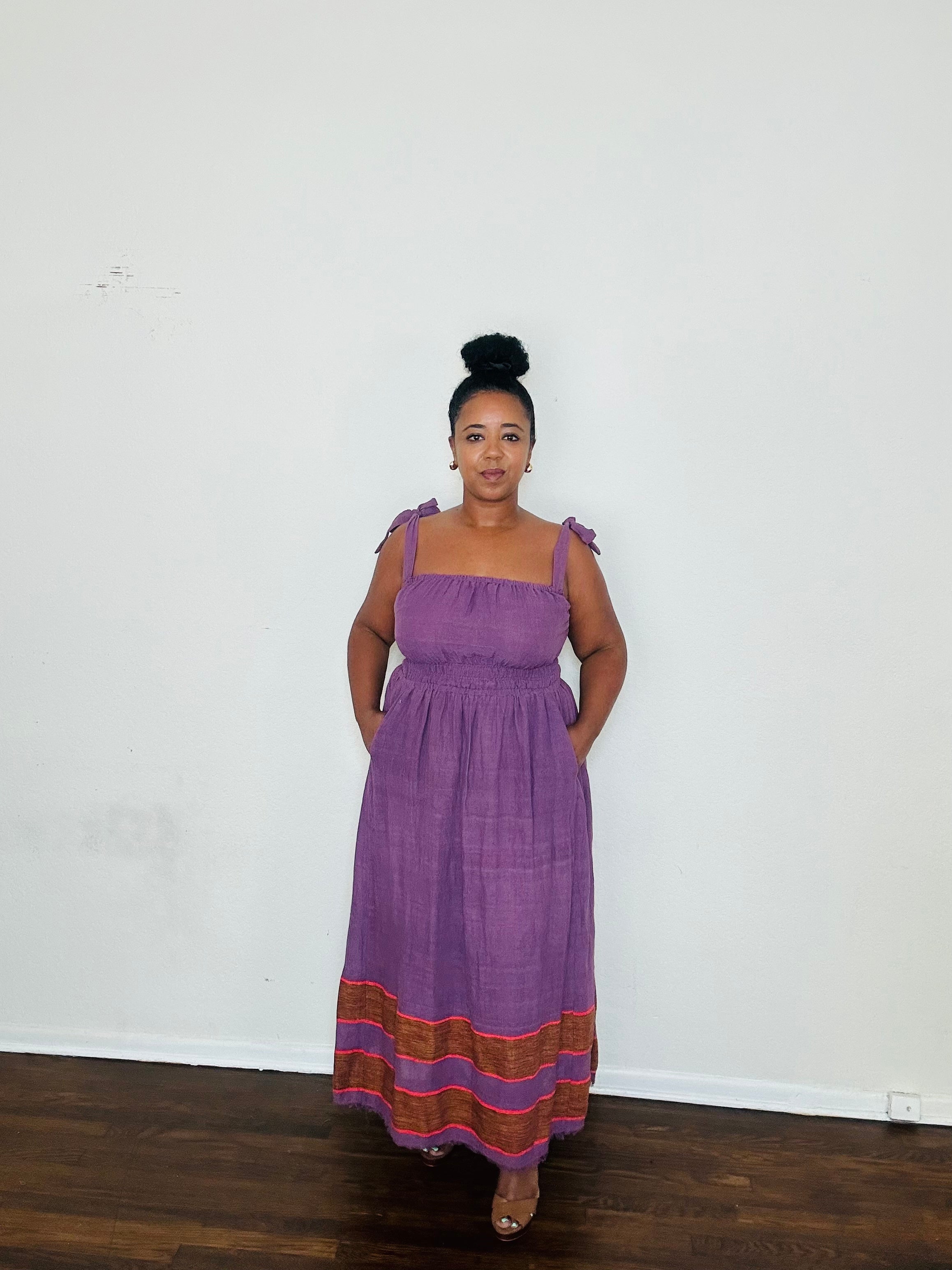 Rawhi Dress Royal Fig — handmade 100% cotton maxi dress with straight neckline, adjustable straps, cinched waist, and flowing A-line silhouette in a rich fig-purple tone, complete with pockets.