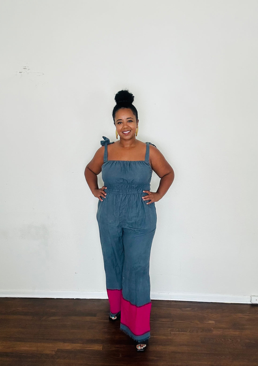 Handmade in Ethiopia from 100% cotton, the Sebie Jumpsuit in Midnight Bloom blends this season’s trending blue slate with a bold fuchsia pink hem for an effortlessly chic statement.