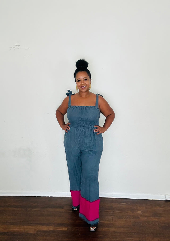 Handmade in Ethiopia from 100% cotton, the Sebie Jumpsuit in Midnight Bloom blends this season’s trending blue slate with a bold fuchsia pink hem for an effortlessly chic statement.