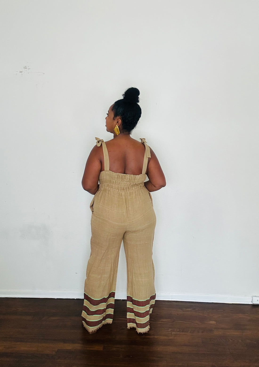 Sebie Jumpsuit in Sahara Clay — handmade 100% cotton khaki jumpsuit with earth-tone hem, versatile for beach-to-city living.