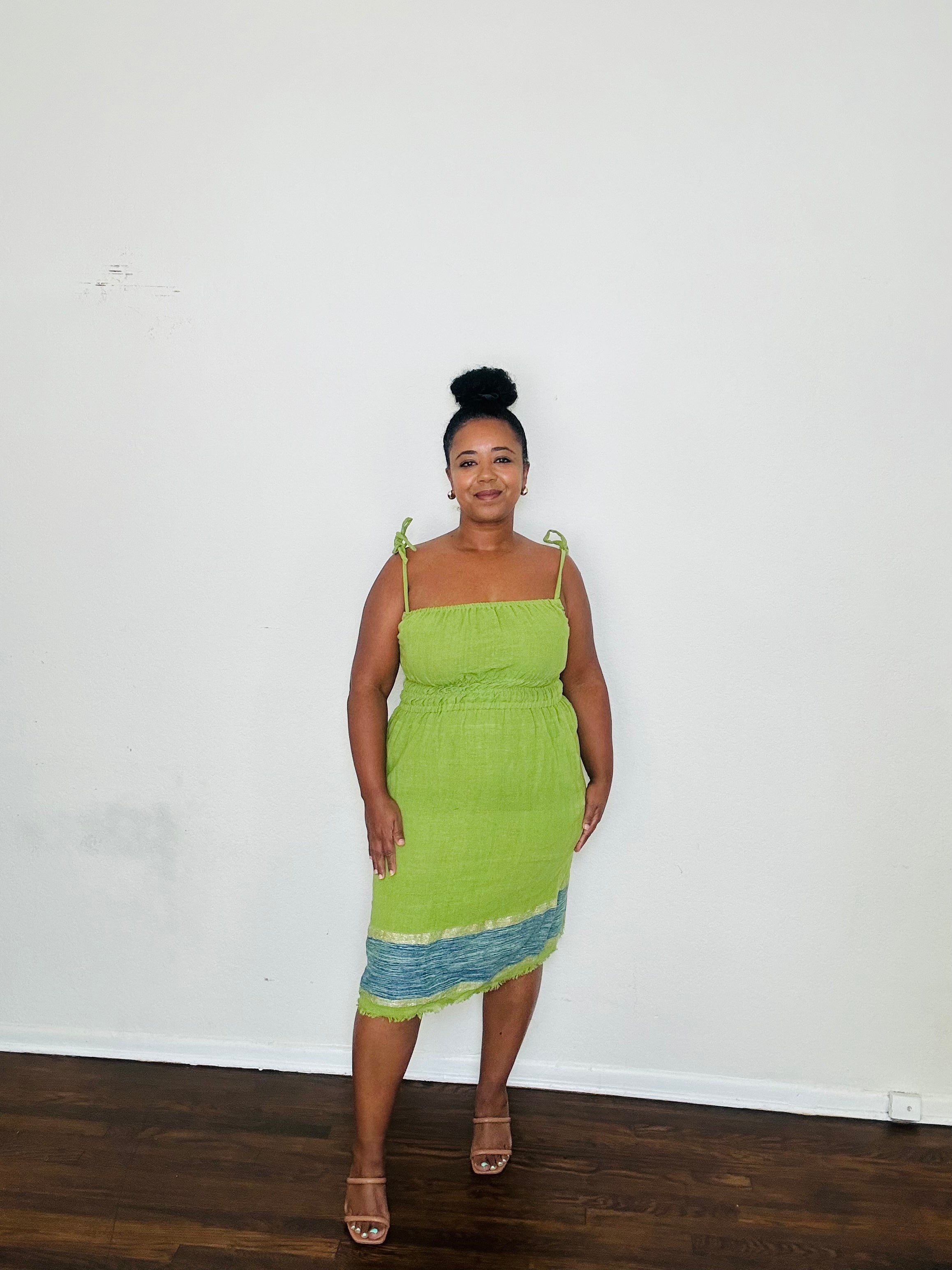 Enani Dress Lime Aura — handmade 100% cotton short dress in lime green with contrasting blue hem, straight neckline, adjustable straps, cinched waist, and hidden pockets.