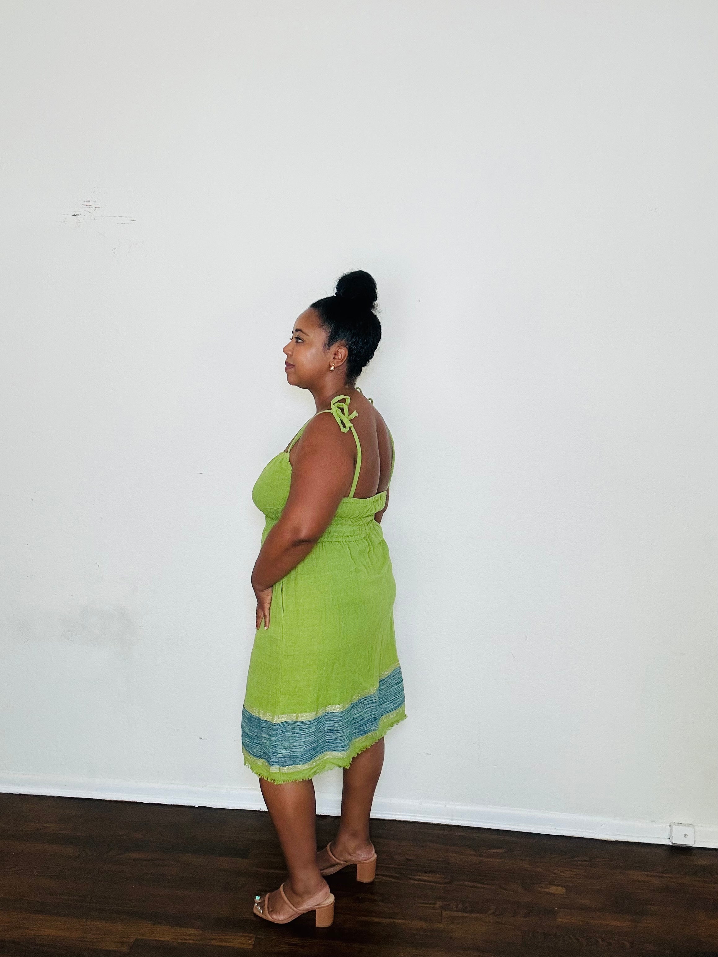 Enani Dress Lime Aura — handmade 100% cotton short dress in lime green with contrasting blue hem, straight neckline, adjustable straps, cinched waist, and hidden pockets.