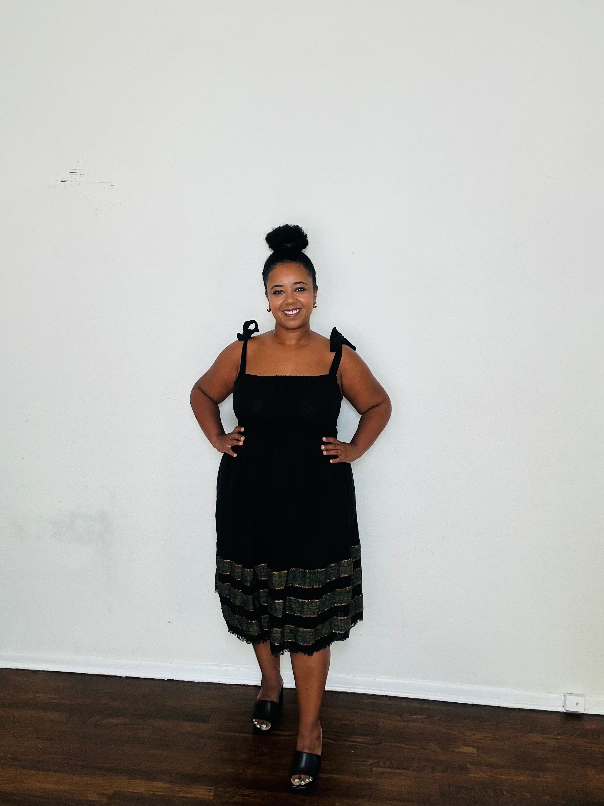 Gelila Dress Obsidian Flow — handmade 100% cotton midi dress with straight neckline, adjustable straps, cinched waist, flowing skirt, and hidden pockets in classic black.
