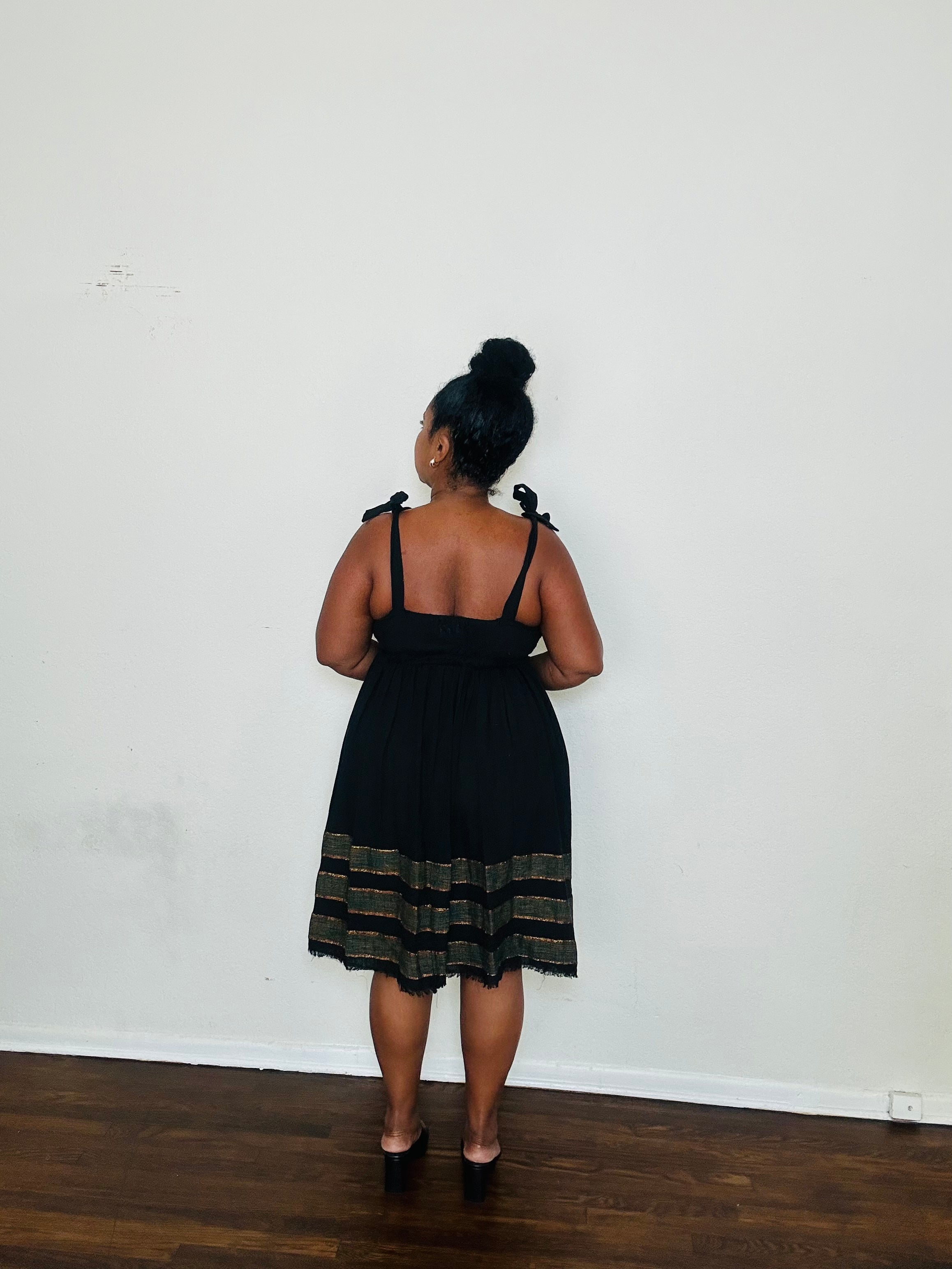 Gelila Dress Obsidian Flow — handmade 100% cotton midi dress with straight neckline, adjustable straps, cinched waist, flowing skirt, and hidden pockets in classic black.
