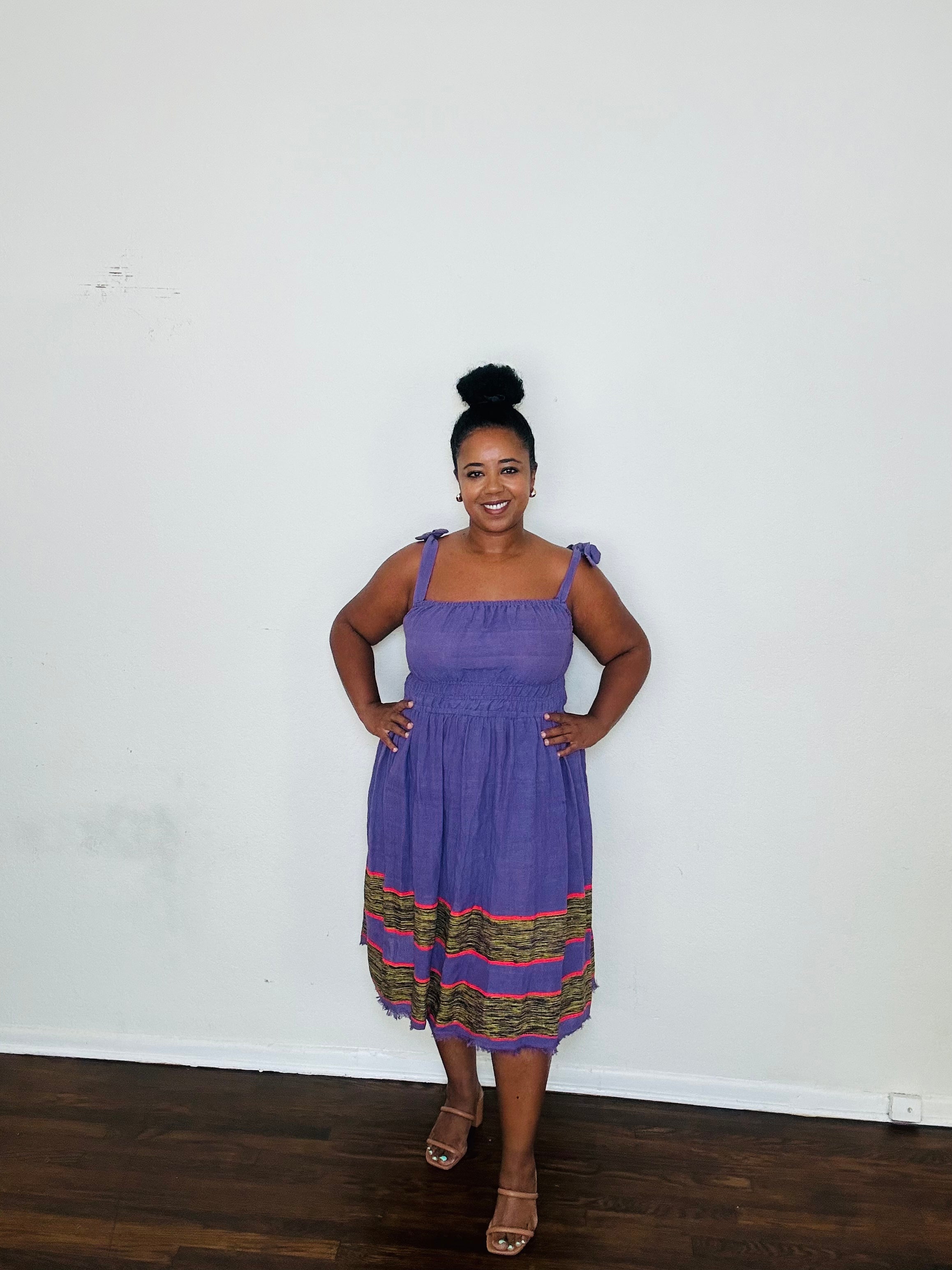 Gelila Dress Twilight Amethyst — handmade 100% cotton midi dress with straight neckline, adjustable straps, cinched waist, flowing skirt, and hidden pockets in a deep purple tone.