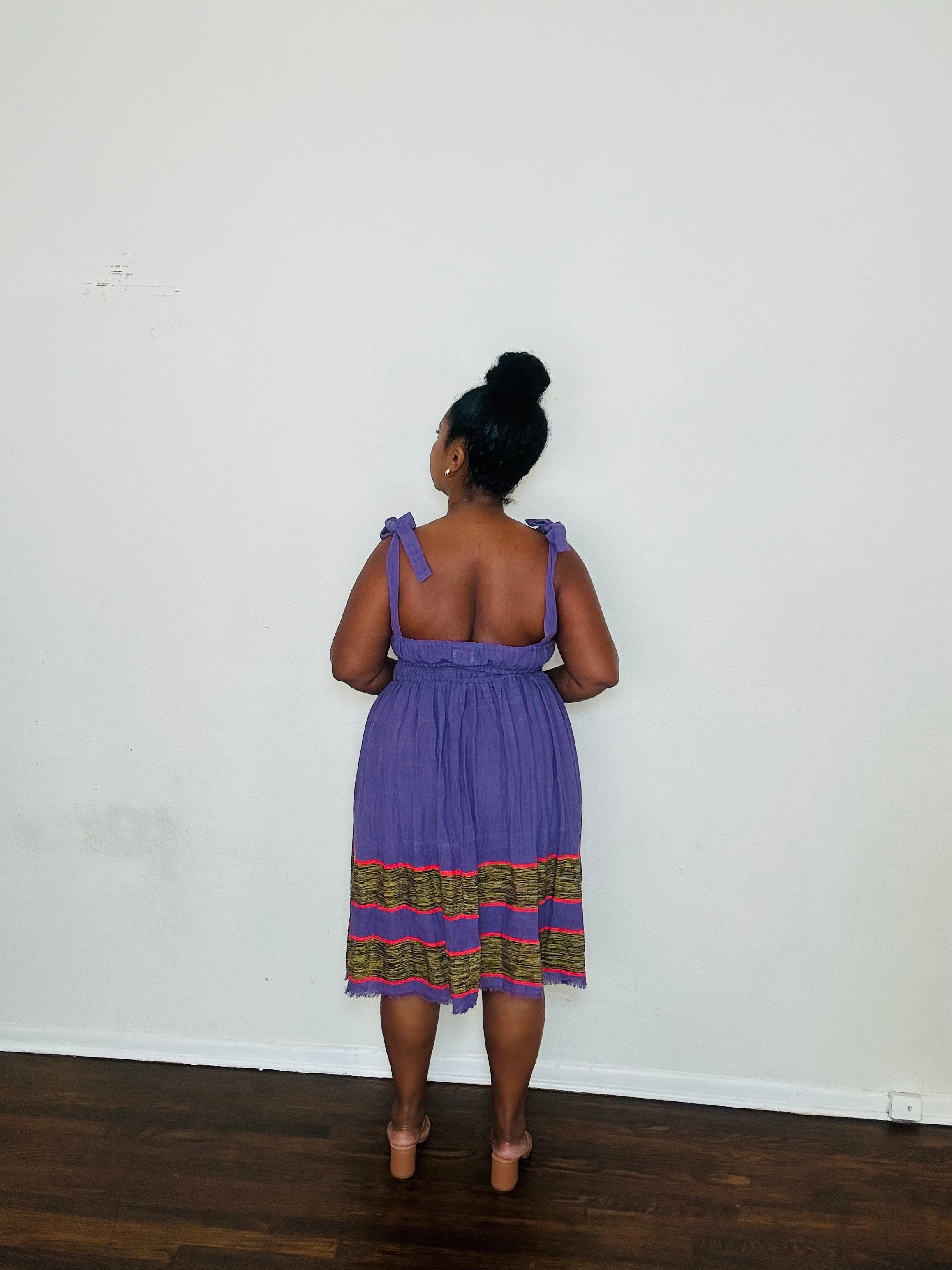 Gelila Dress Twilight Amethyst — handmade 100% cotton midi dress with straight neckline, adjustable straps, cinched waist, flowing skirt, and hidden pockets in a deep purple tone.