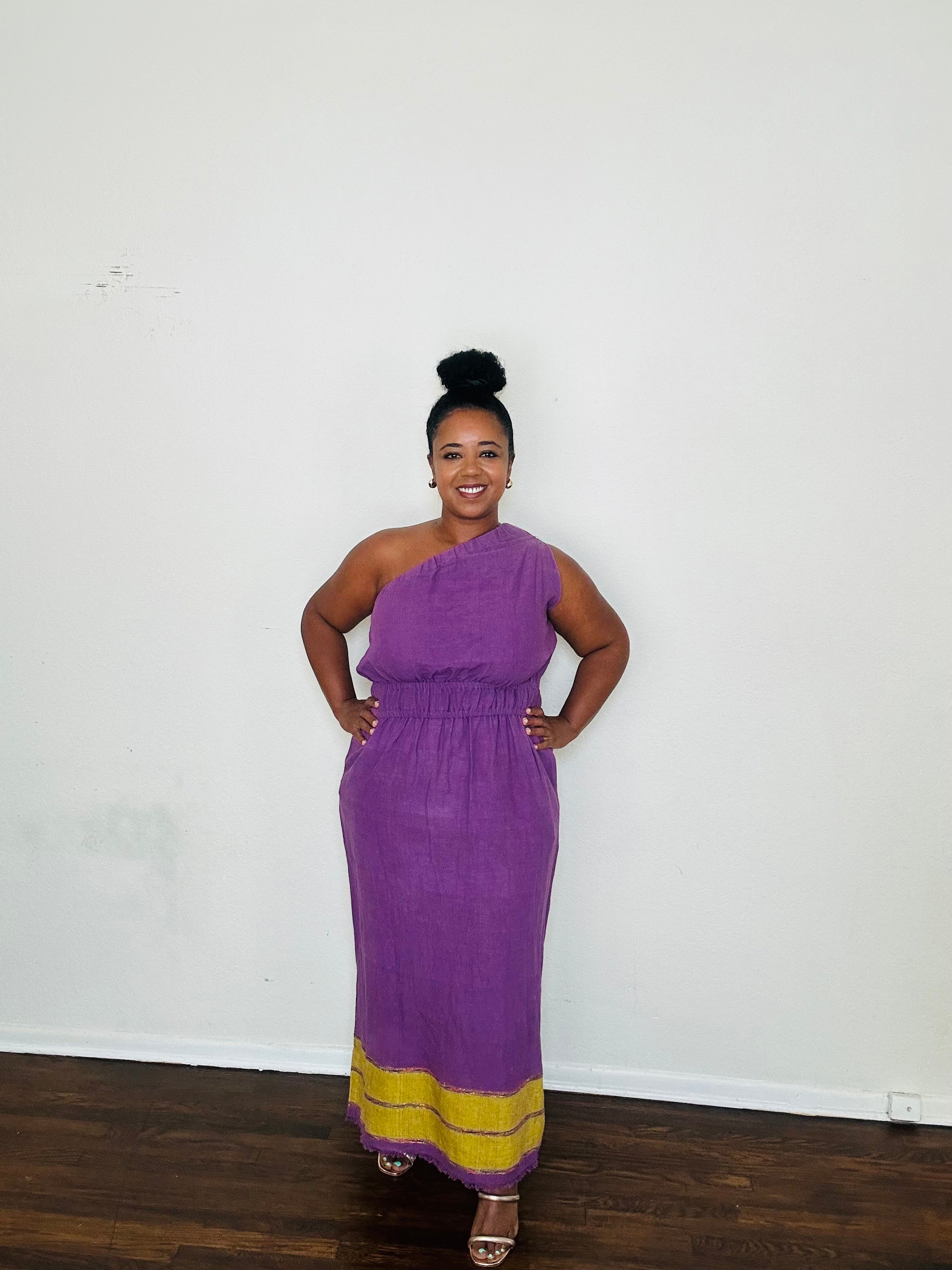 Marye Dress Crown Violet — handmade 100% cotton maxi dress with one-shoulder neckline, cinched waist, flowing A-line silhouette, and side slits in a regal violet tone.