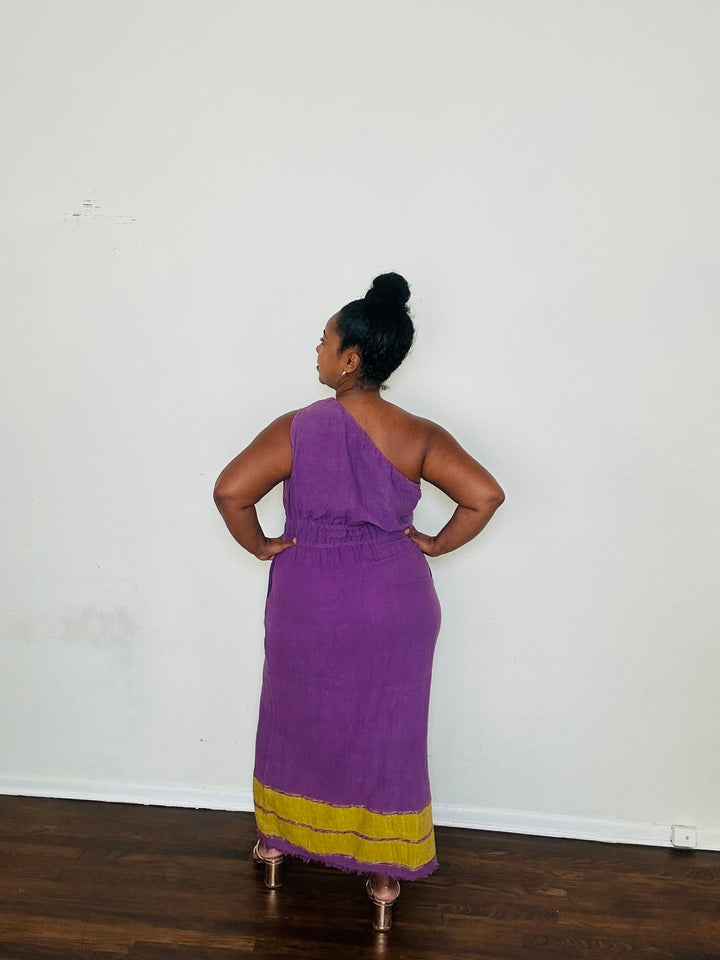 Marye Dress Crown Violet — handmade 100% cotton maxi dress with one-shoulder neckline, cinched waist, flowing A-line silhouette, and side slits in a regal violet tone.
