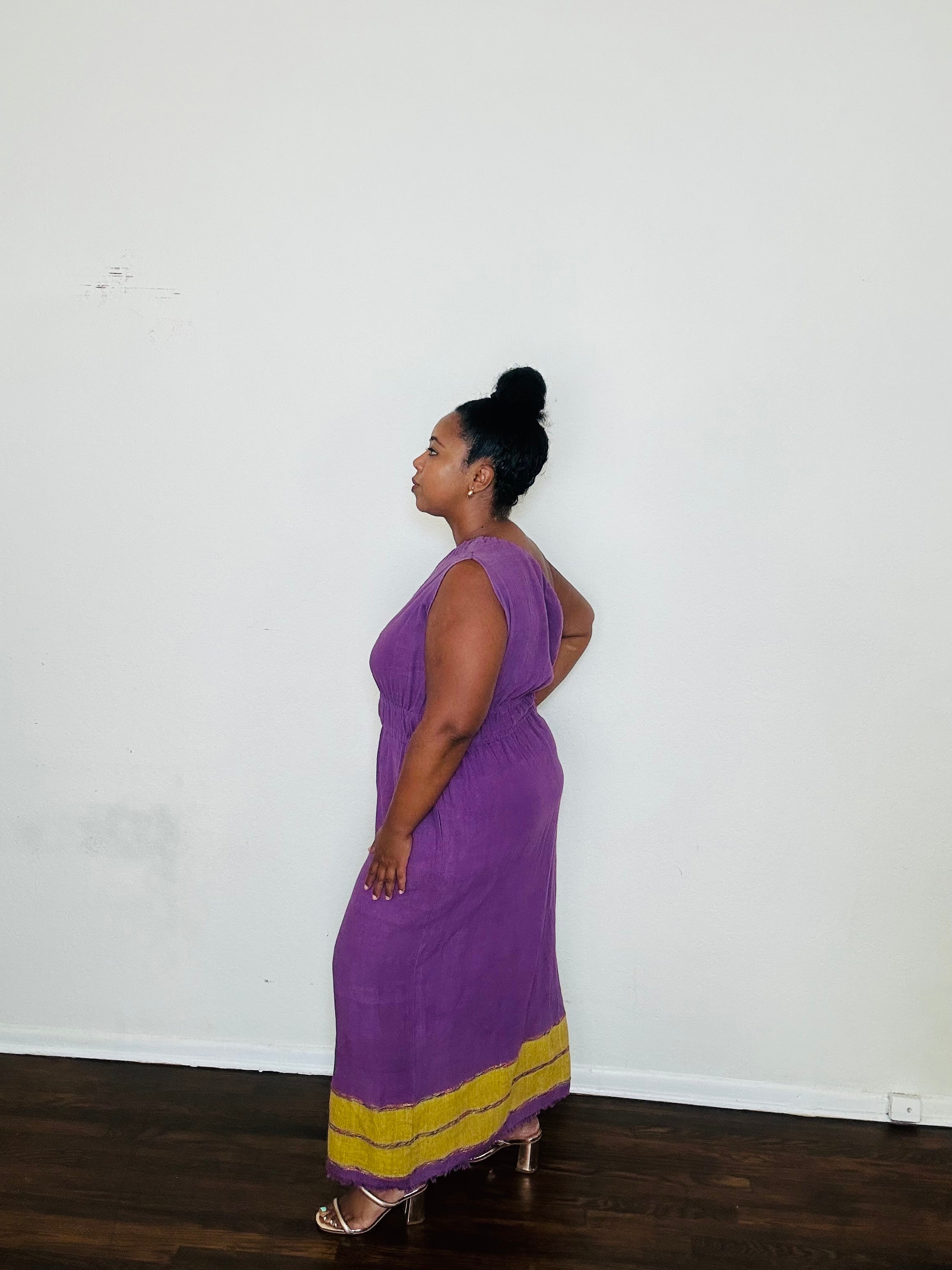Marye Dress Crown Violet — handmade 100% cotton maxi dress with one-shoulder neckline, cinched waist, flowing A-line silhouette, and side slits in a regal violet tone.
