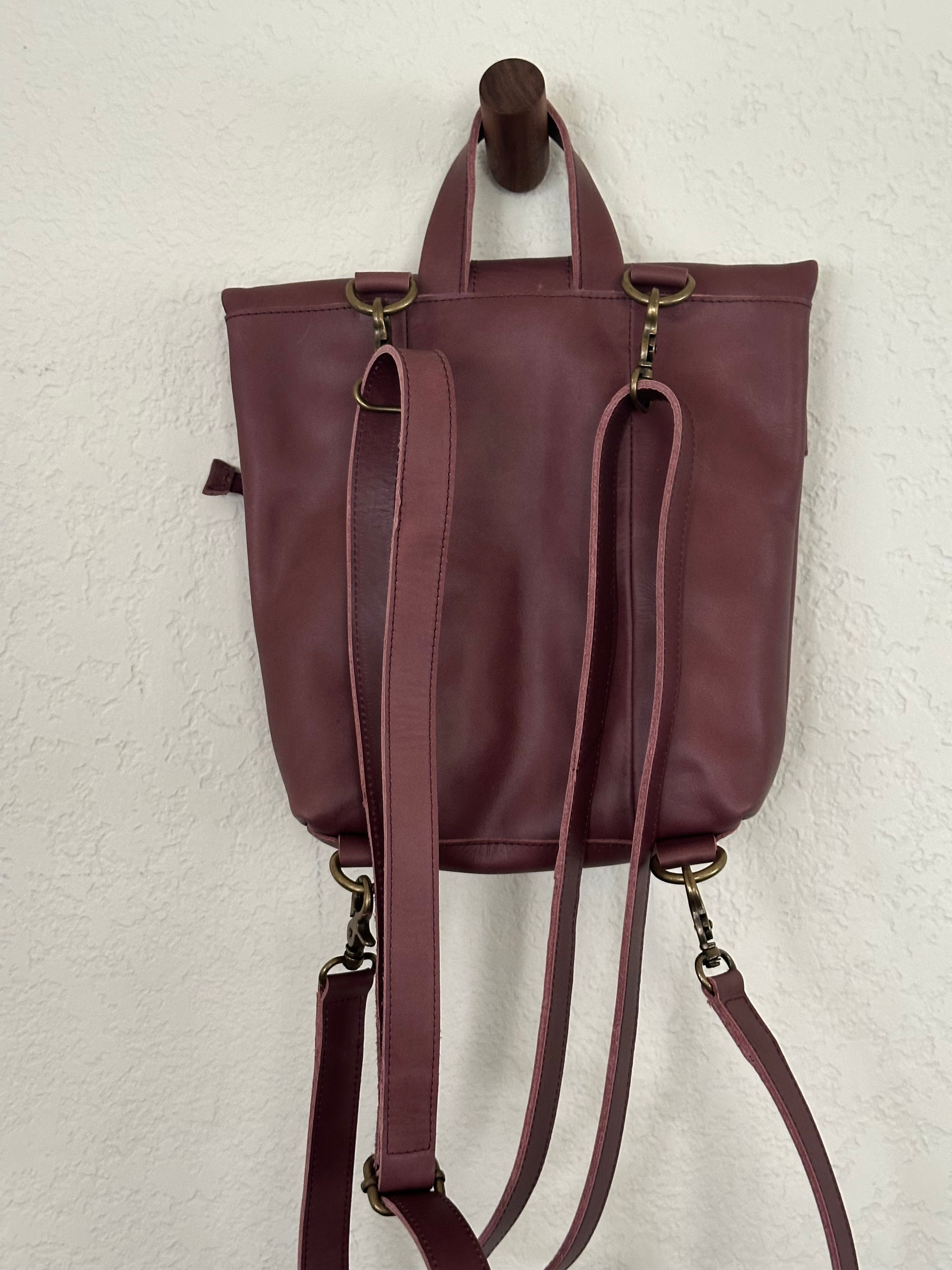 ShopYego Omo Backpack Garnet Desert Rose – compact artisan leather daypack in trending deep wine red with pink checkered accents, handmade in Ethiopia, everyday crossbody style