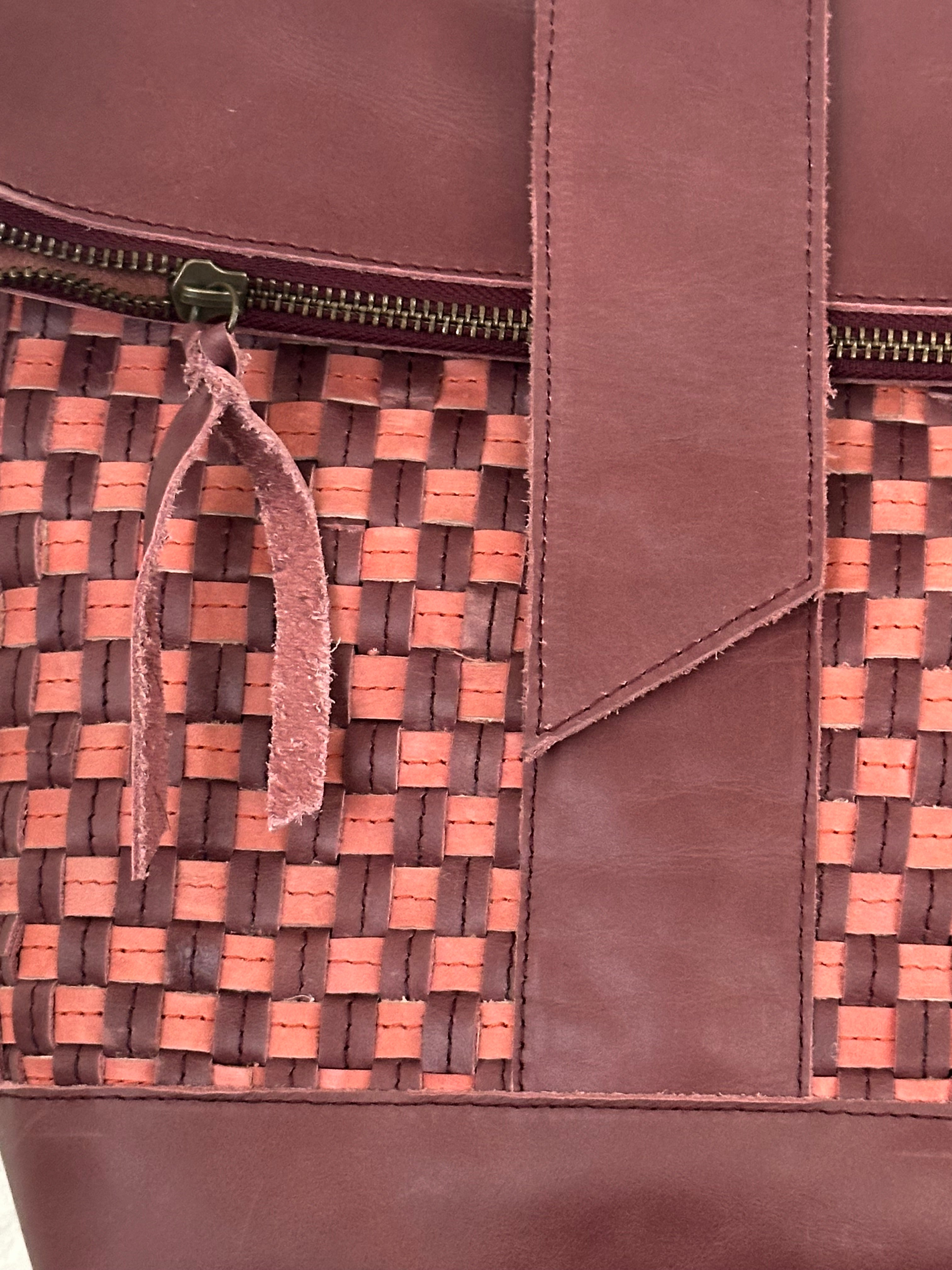 ShopYego Omo Backpack Garnet Desert Rose – compact artisan leather daypack in trending deep wine red with pink checkered accents, handmade in Ethiopia, everyday crossbody style