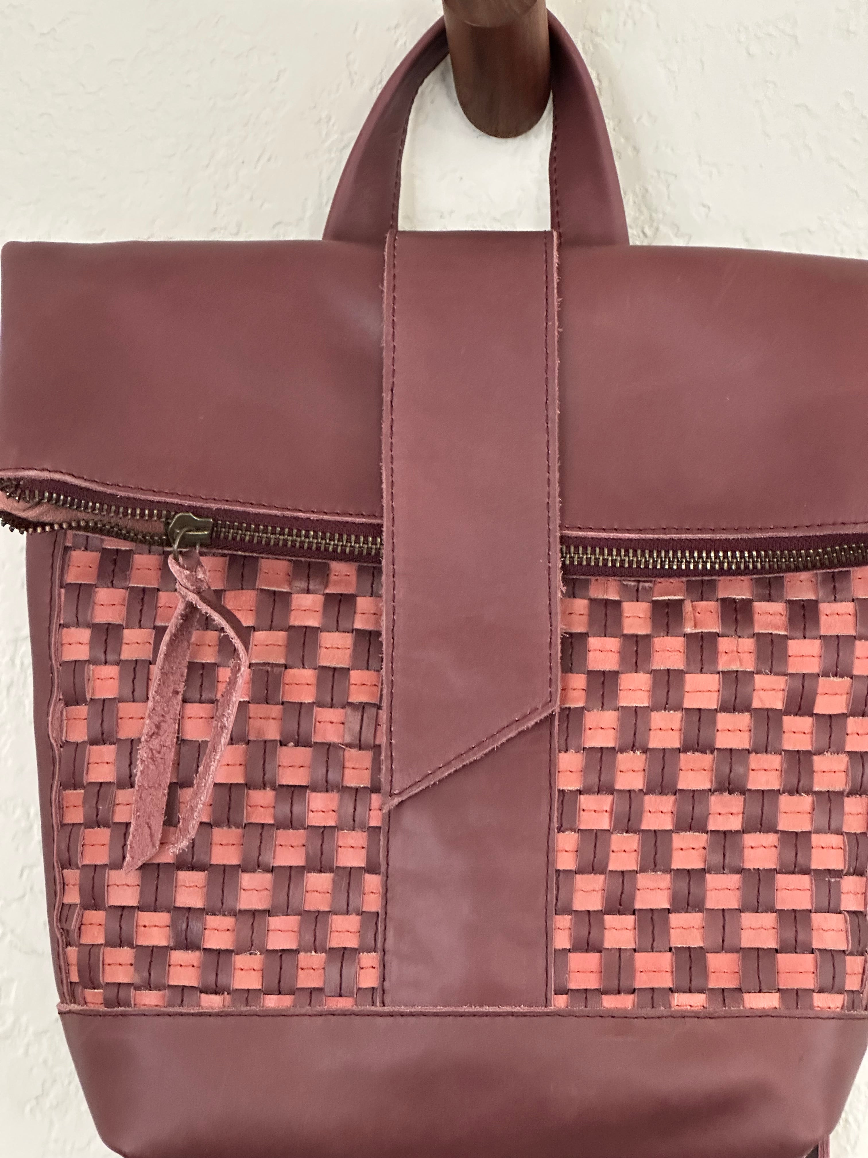 ShopYego Omo Backpack Garnet Desert Rose – compact artisan leather daypack in trending deep wine red with pink checkered accents, handmade in Ethiopia, everyday crossbody style