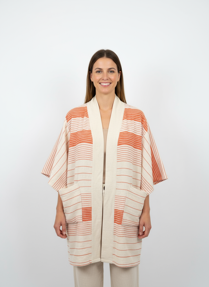 Handmade Zelalem Cardi in Solar Orange — persimmon and cream striped cardigan, 100% cotton, breathable, soft transitional layer.