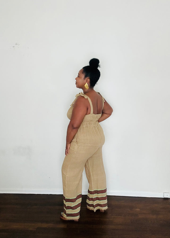 Sebie Jumpsuit in Sahara Clay — handmade 100% cotton khaki jumpsuit with earth-tone hem, versatile for beach-to-city living.