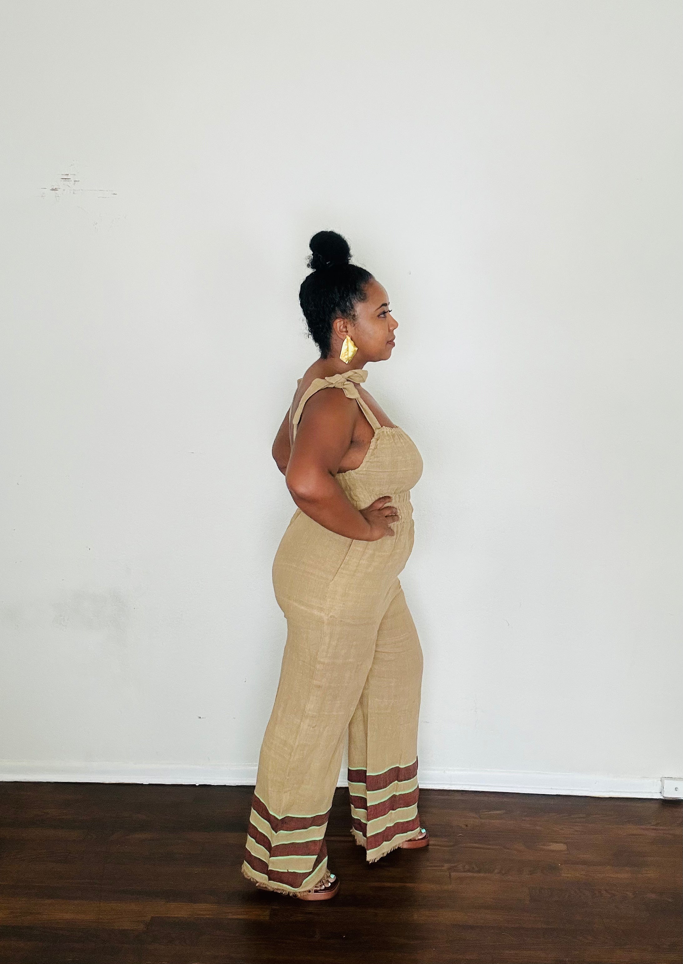 Sebie Jumpsuit in Sahara Clay — handmade 100% cotton khaki jumpsuit with earth-tone hem, versatile for beach-to-city living.