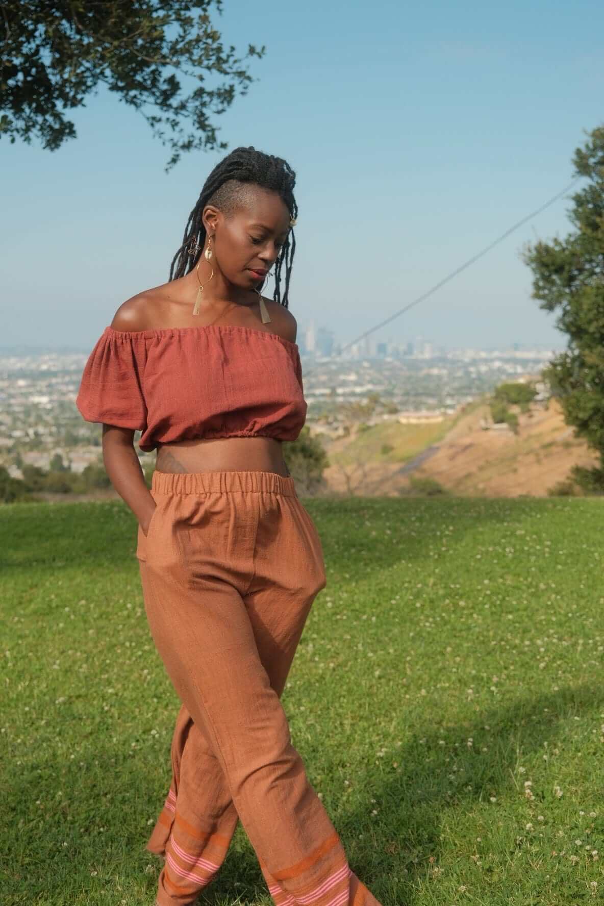 Rahel Pants Sandalwood — handmade 100% cotton pants with relaxed silhouette, elastic waist, side pockets, and breathable design in a light brown sandalwood tone.