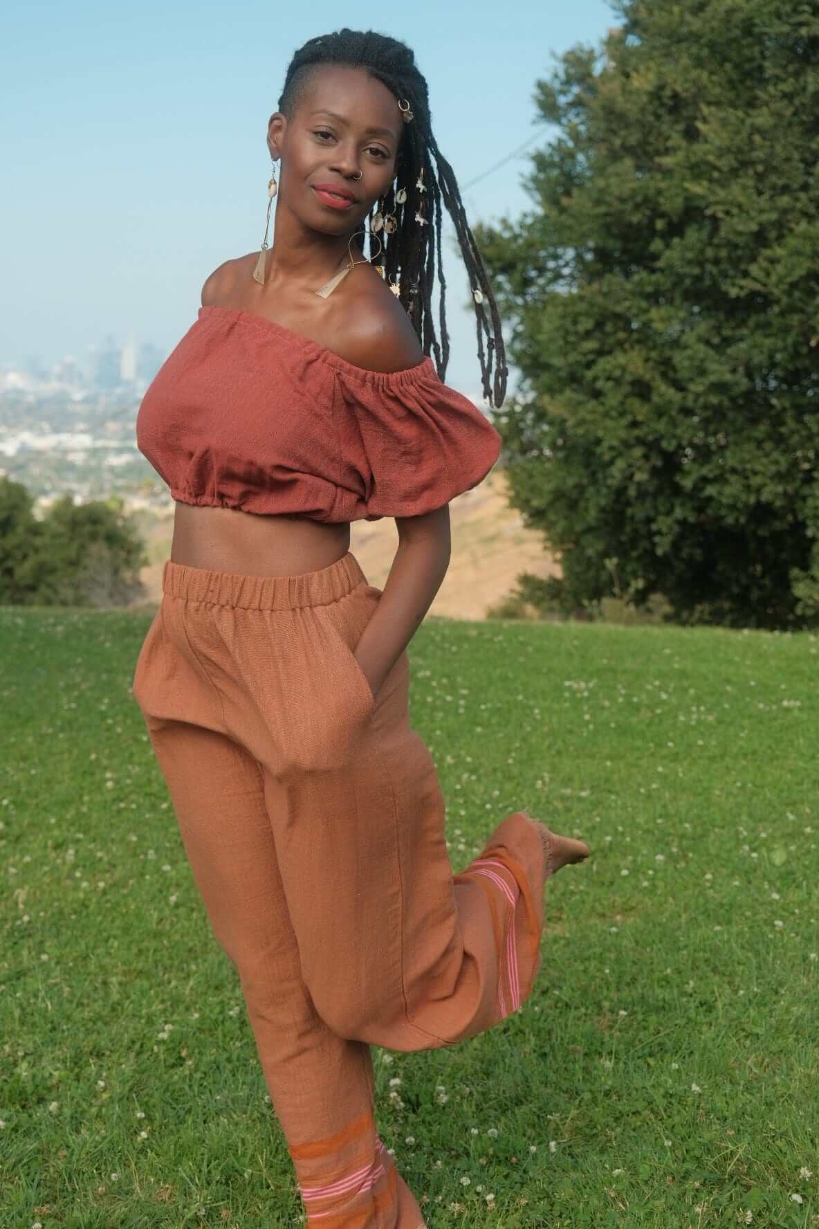 Rahel Pants Sandalwood — handmade 100% cotton pants with relaxed silhouette, elastic waist, side pockets, and breathable design in a light brown sandalwood tone.