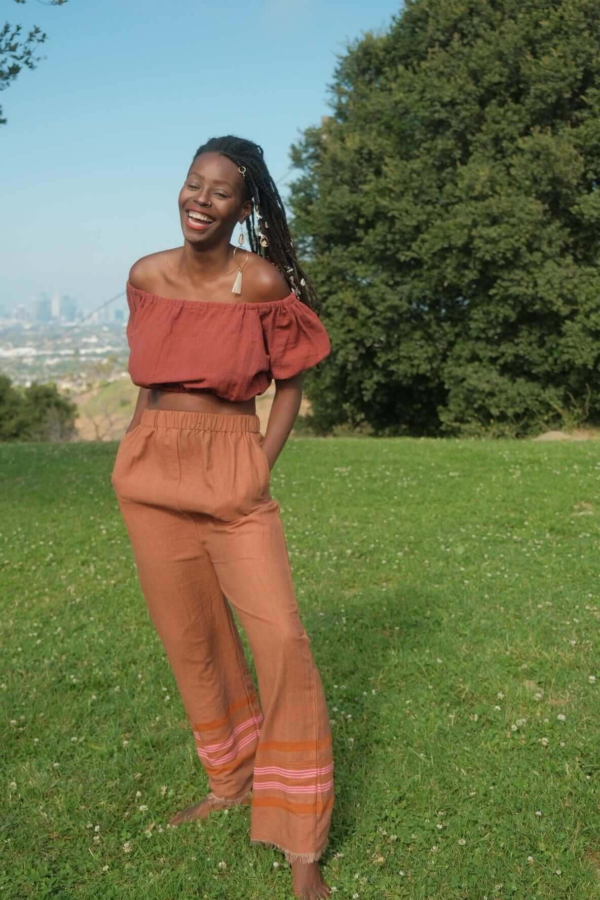 Rahel Pants Sandalwood — handmade 100% cotton pants with relaxed silhouette, elastic waist, side pockets, and breathable design in a light brown sandalwood tone.