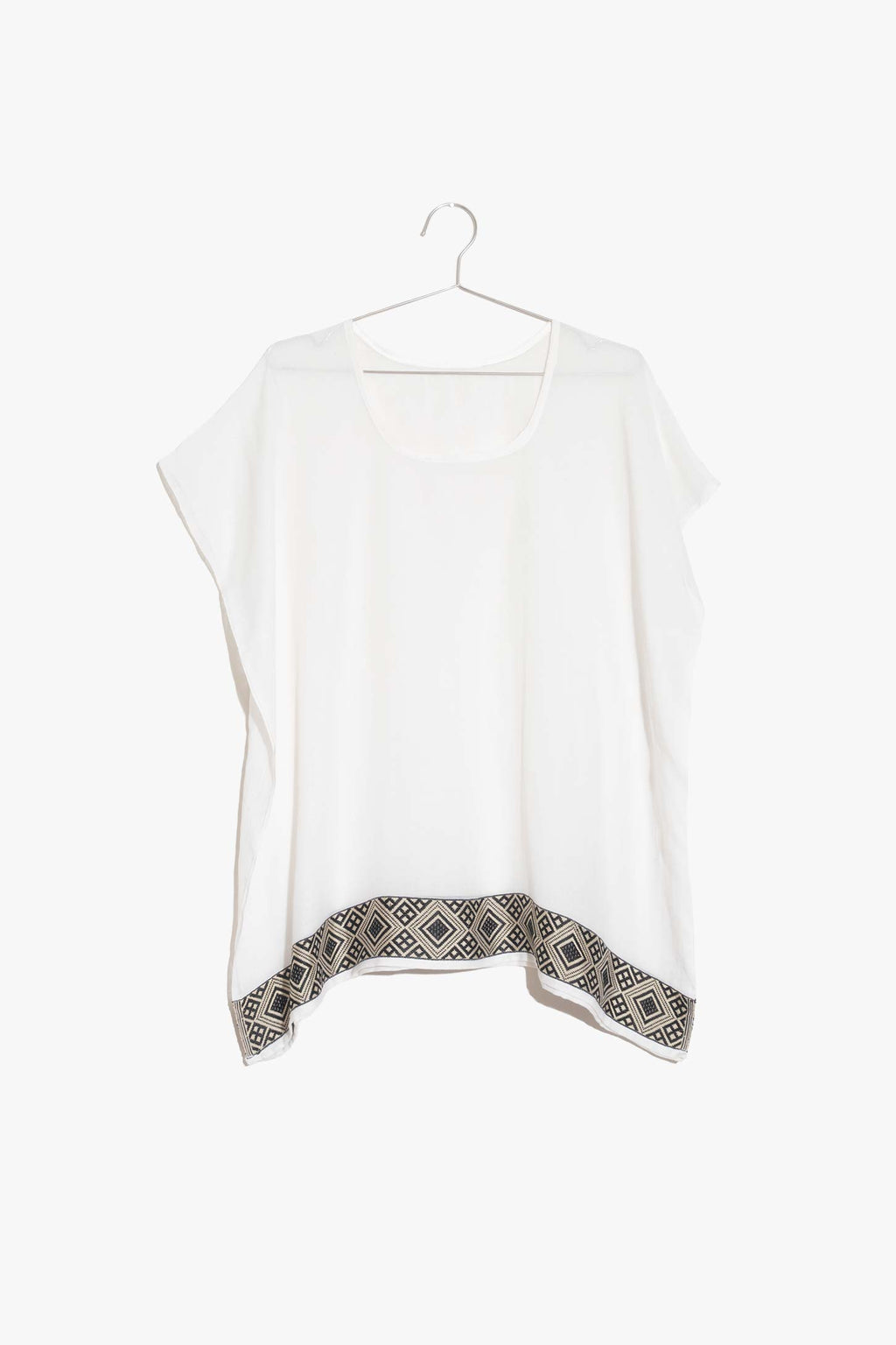 The Lulu Top is like your oversized tee but better. This semi-sheer cotton top is comfy without sacrificing style. It features a rich pattern along the bottom hem, inspired by Ethiopian textile design